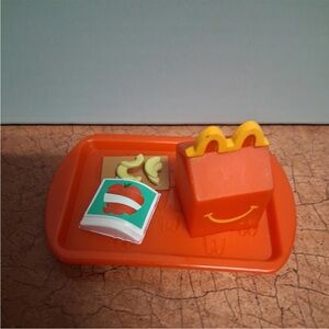 Lil mcdonalds trays with milk, chicken McNuggets and apples